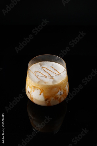 Creamy macchiato on the black background