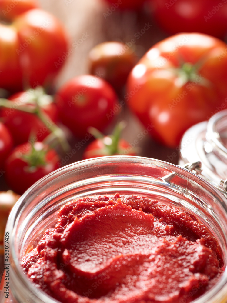 Tomatoes and tomato paste on table Tomatoes and tomato paste on table