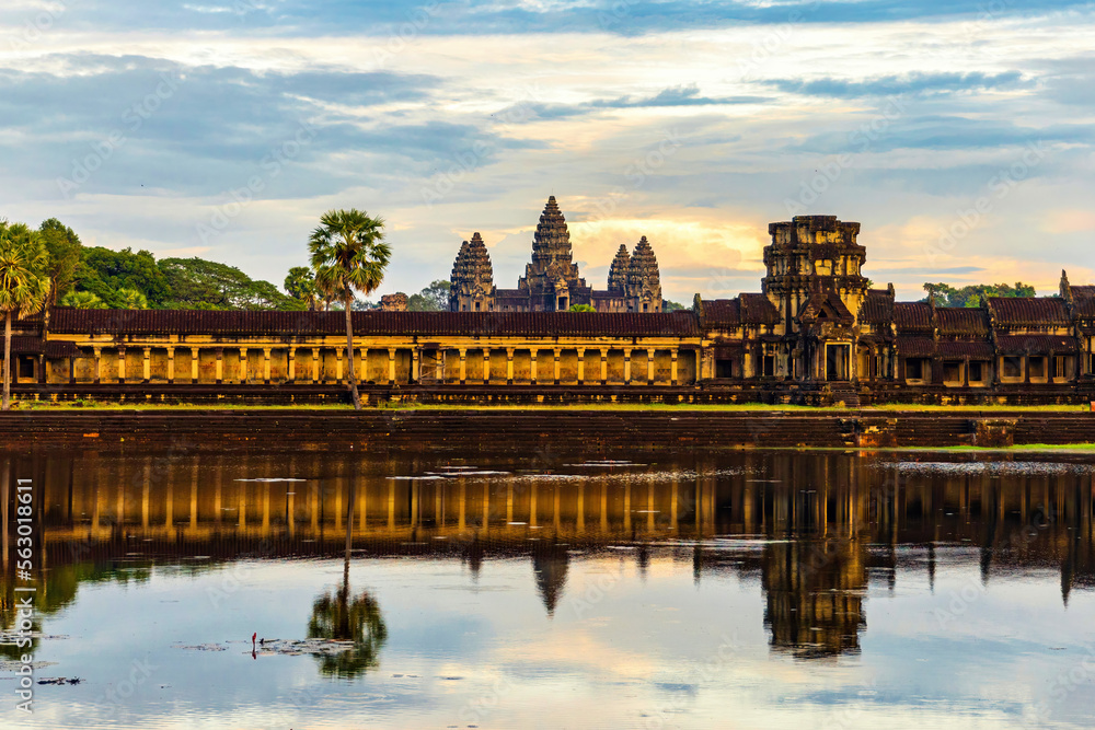 Angkor Wat temple reflecting in water before sunset