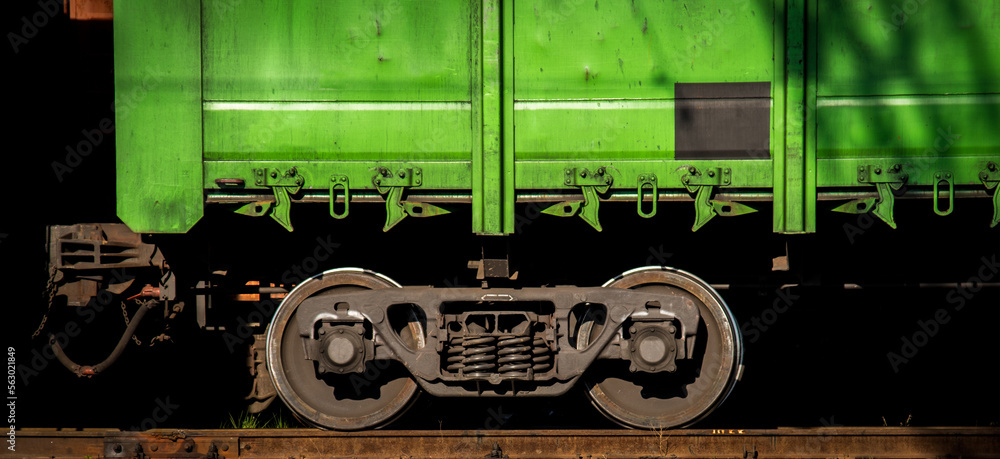 Abstract image of the wheels of a railway freight car on a track.