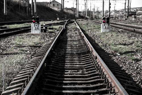 Obraz na płótnie Abstract image with red semaphore lights on both sides of a railway track. w salonie