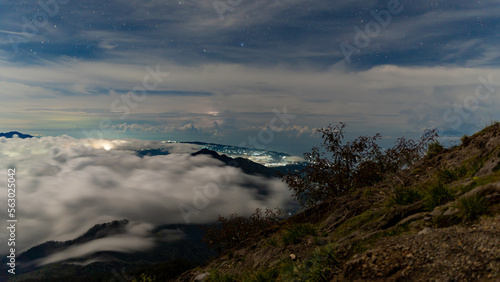 Night at the top of the Agung volcano. Panoramic view of East Java and Bali against the background of clouds. The background of the natural landscape. Bali Island, Indonesia © Amazing Travel Stock