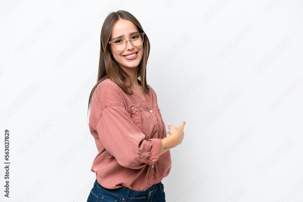 Obraz premium Young pretty caucasian woman isolated on white background pointing back