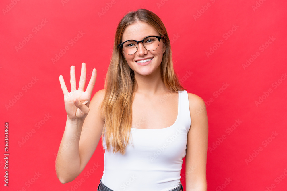 Young beautiful woman isolated on red background happy and counting four with fingers Young beautiful woman isolated on red background happy and counting four with fingers