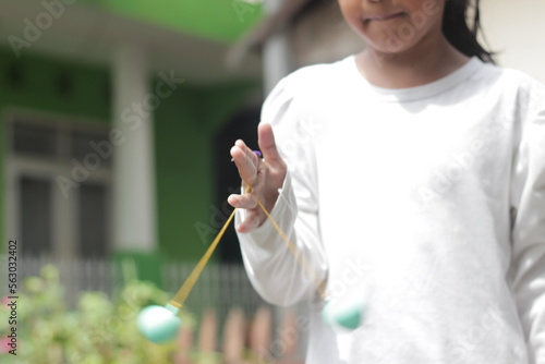 Asian girl is playing a game that is curently going viral in Indonesia, latto latto. Selective focus photo