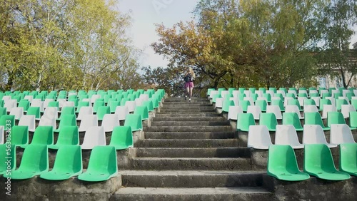 The girl leaves the football stadium . Canceled match, game. without fans. 