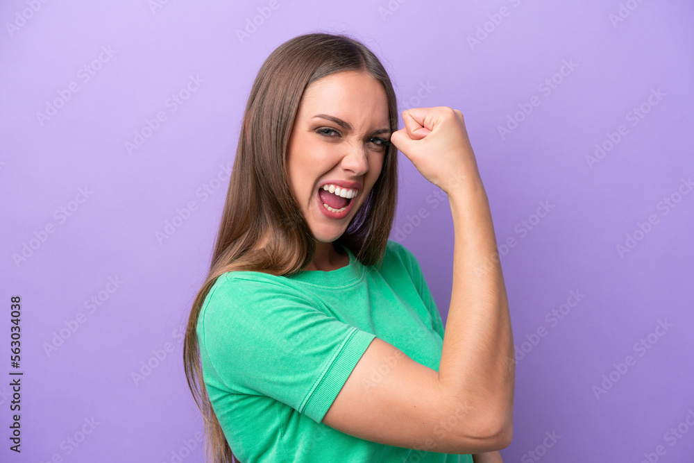Young caucasian woman isolated on purple background doing strong gesture Young caucasian woman isolated on purple background doing strong gesture