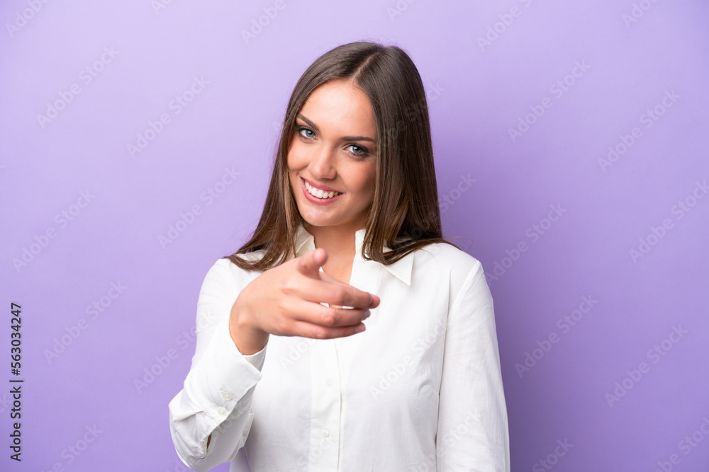 Young caucasian woman isolated on purple background pointing front with happy expression Young caucasian woman isolated on purple background pointing front with happy expression