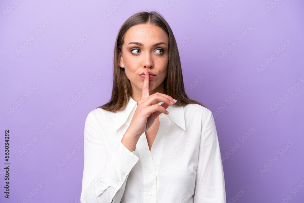 Young caucasian woman isolated on purple background showing a sign of silence gesture putting finger in mouth Young caucasian woman isolated on purple background showing a sign of silence gesture putting finger in mouth