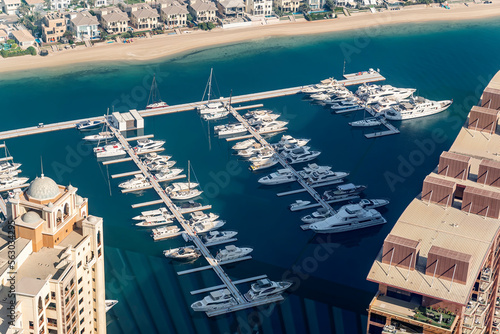 Fototapeta Naklejka Na Ścianę i Meble -  fast boats and luxury yachts are parked in the port at the pier near beach. View from above.