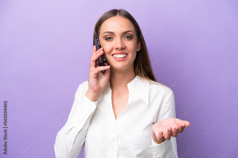 Young caucasian woman isolated on purple background keeping a conversation with the mobile phone with someone Young caucasian woman isolated on purple background keeping a conversation with the mobile phone with someone