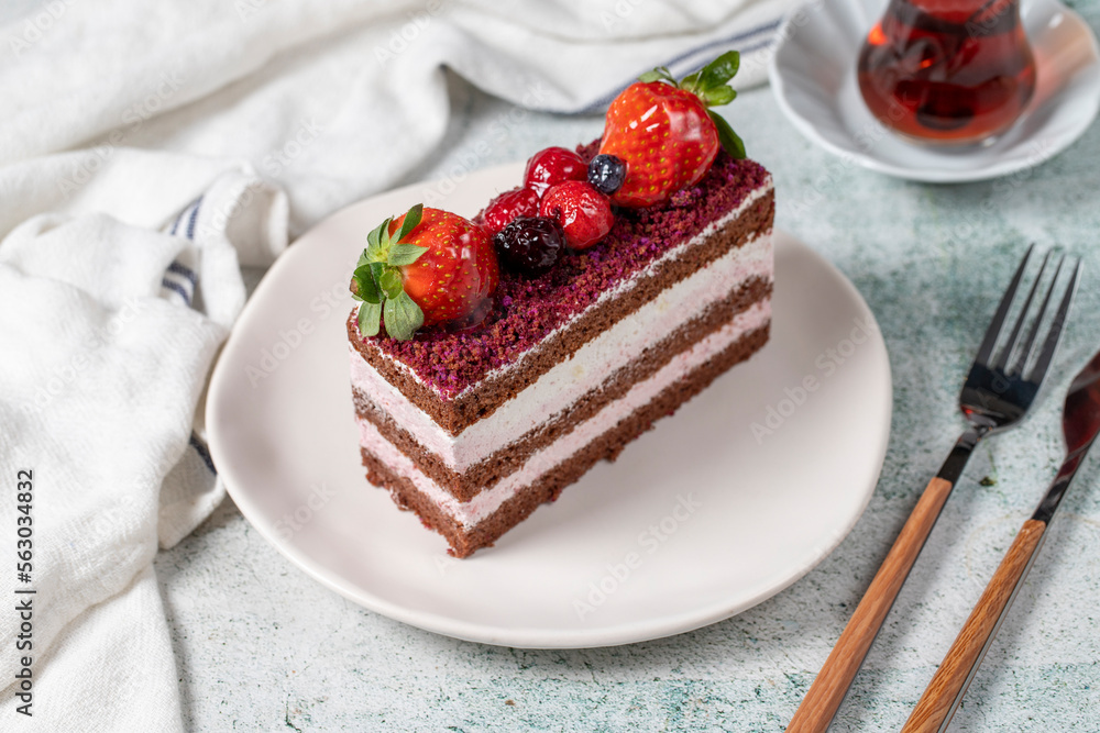 Fruit and whipped cream cake. Layered cake with forest fruit and cream on the plate. close up Fruit and whipped cream cake. Layered cake with forest fruit and cream on the plate. close up