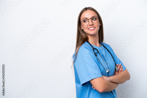 Young nurse caucasian woman isolated on white background with arms crossed and happy