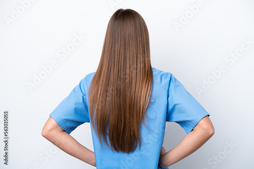 Young nurse caucasian woman isolated on white background in back position