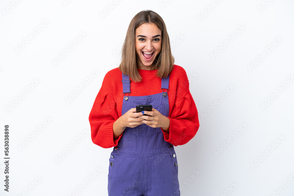 Young caucasian woman isolated on white background surprised and sending a message Young caucasian woman isolated on white background surprised and sending a message