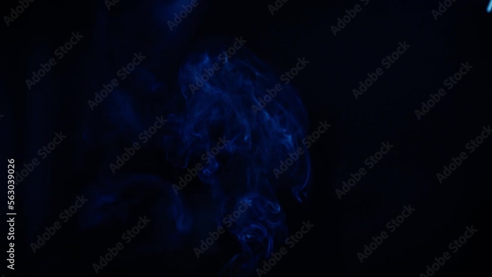 Incense sticks burn and smoke on a black background, incense smoke. Slow motion. Incense sticks burn and smoke on a black background, incense smoke. Slow motion.