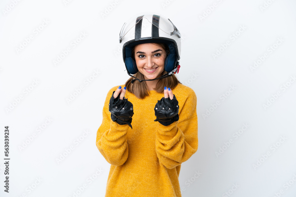 Young caucasian woman with a motorcycle helmet isolated on white background making money gesture Young caucasian woman with a motorcycle helmet isolated on white background making money gesture