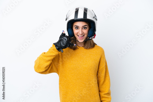 Young caucasian woman with a motorcycle helmet isolated on white background making phone gesture. Call me back sign