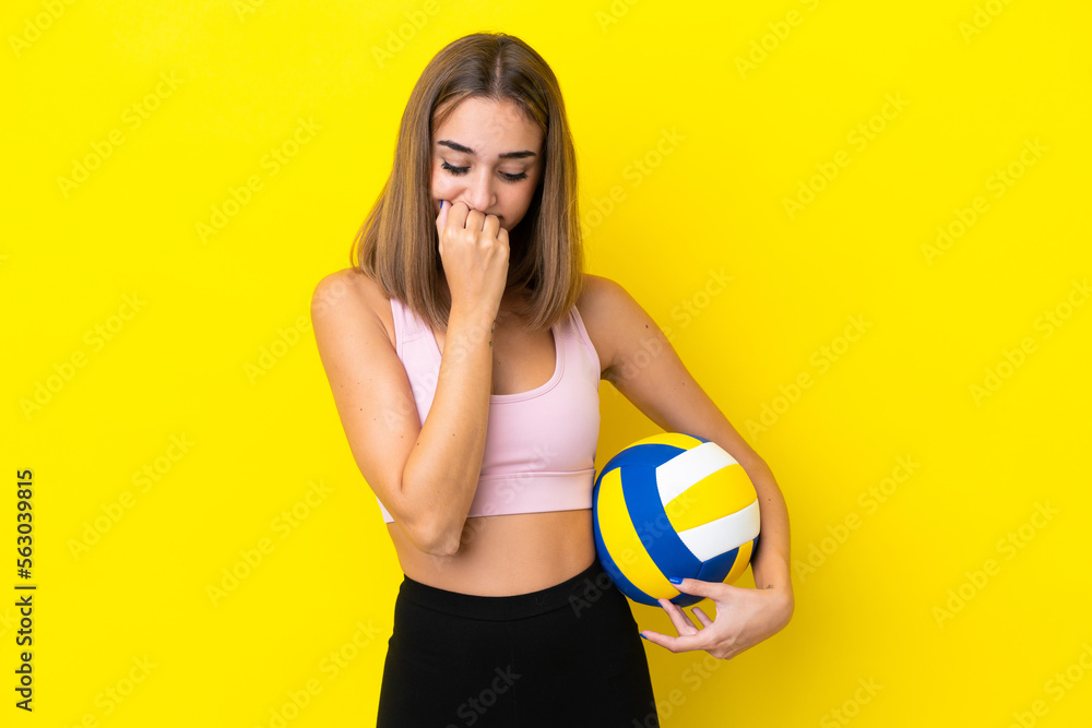 Young woman playing volleyball isolated on yellow background having doubts Young woman playing volleyball isolated on yellow background having doubts