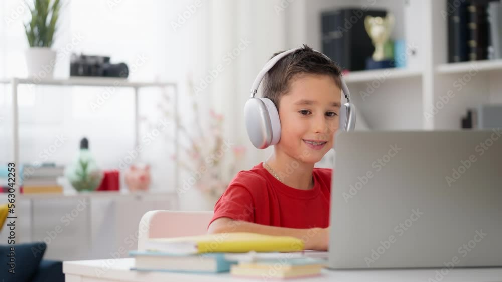 Little boy having video call with private tutor, remote education, homeschooling