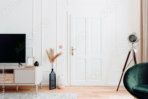 Interior design details with personal items, vases, chair and tv stand. High end design of contemporary home