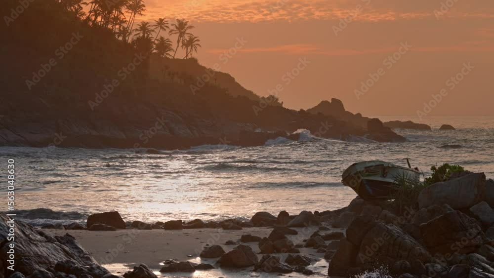 Dawn on a tropical island. A small secret beach in the south of the island of Sri Lanka. Fishing boat on the shore. Merissa Secret Beach Dawn on a tropical island. A small secret beach in the south of the island of Sri Lanka. Fishing boat on the shore. Merissa Secret Beach