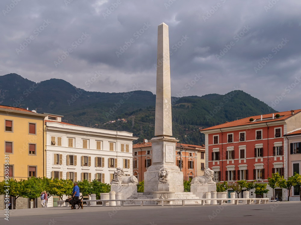 The obelisk in Piazza Aranci square, Massa, Italy, under a dramatic sky