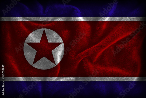 North Korean flag illustration (representing the colors of North Korea - red white blue white with a star) with dark textured fabric background