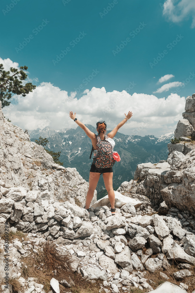 A hiker girl travels with a backpack in the Prokletie mountains. Trekking trails of Albania