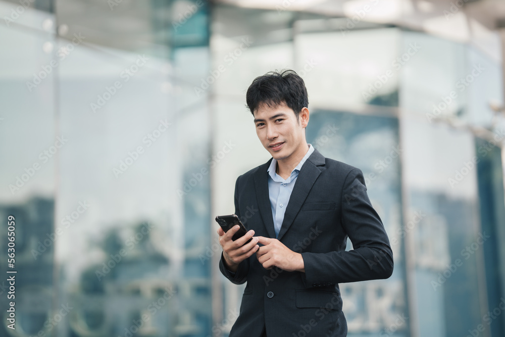 View of a Young attractive asian business man using smartphone. View of a Young attractive asian business man using smartphone.