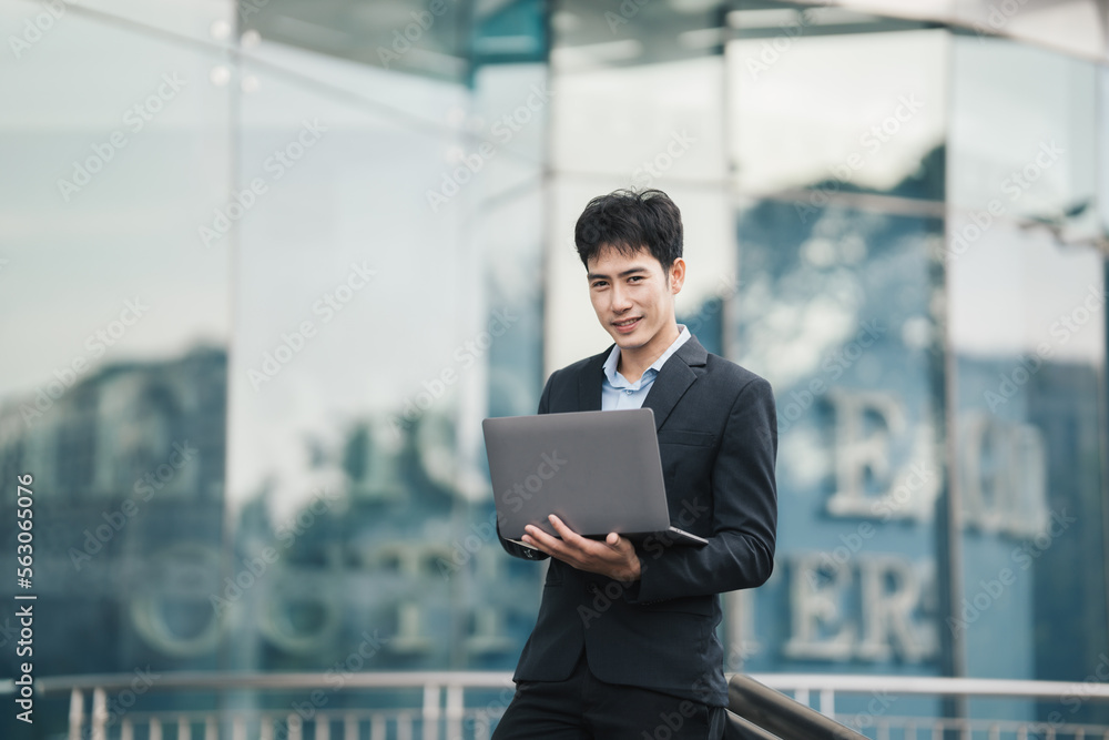 Handsome young manager working on laptop while sitting outdoors on the stairs, concept of work life balance. Handsome young manager working on laptop while sitting outdoors on the stairs, concept of work life balance.