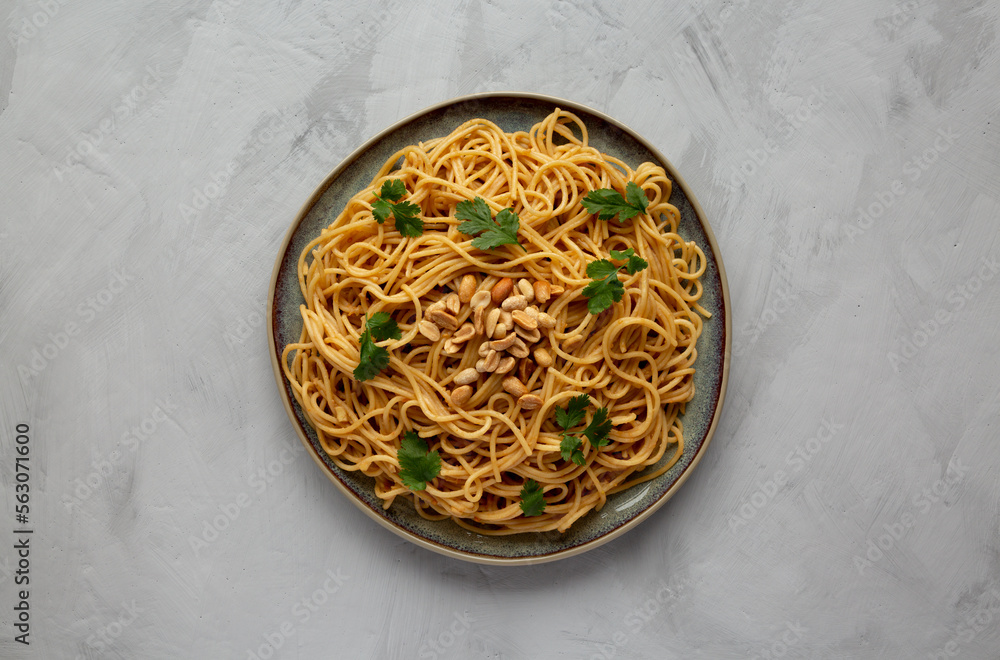 Homemade Asian Peanut Sauce Noodles on a Plate, top view. Flat lay, overhead, from above.