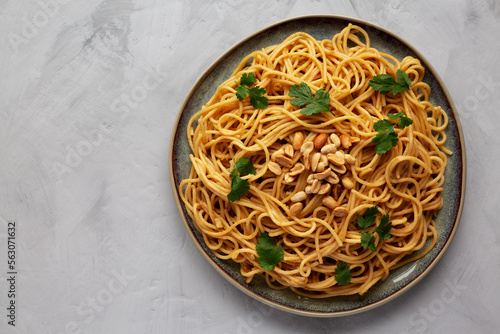 Homemade Asian Peanut Sauce Noodles on a Plate, top view. Flat lay, overhead, from above. Space for text.