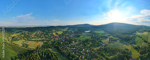 Overhead view of beautiful suburb landscape, Aerial view of countryside area with village and green fields near mountains