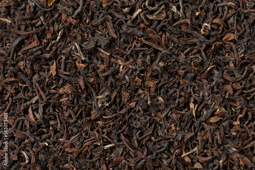 Indian Tukvar darjeeling dried tea leaves close up full frame as background