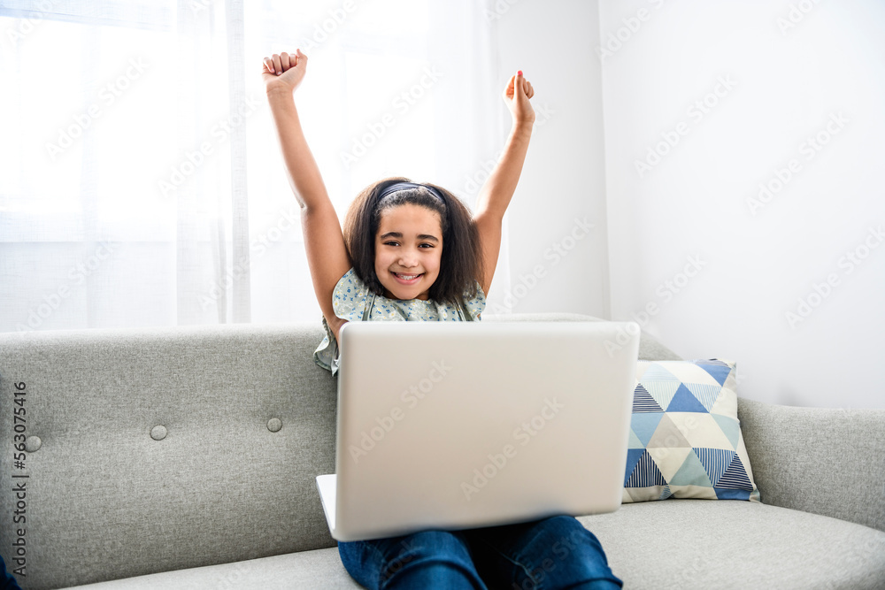 portrait of cute child using laptop on sofa portrait of cute child using laptop on sofa