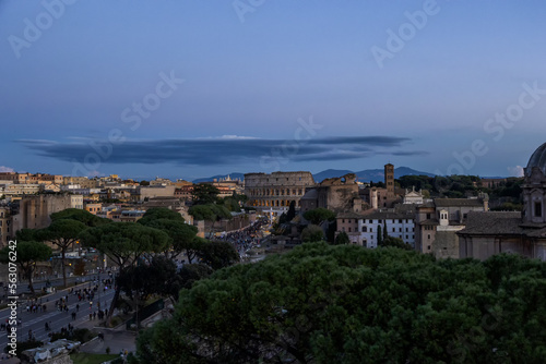 Focus on the Colosseum with Via dei Fori Imperiali street in the historic center of Rome, Italy at night