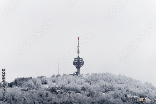 Winter view of destroyed Sarajevo TV Tower. The Hum Tower or Toranj Hum is a telecommunication tower located on Mount Hum in the periphery of Sarajevo. Symbol of a city.  photo