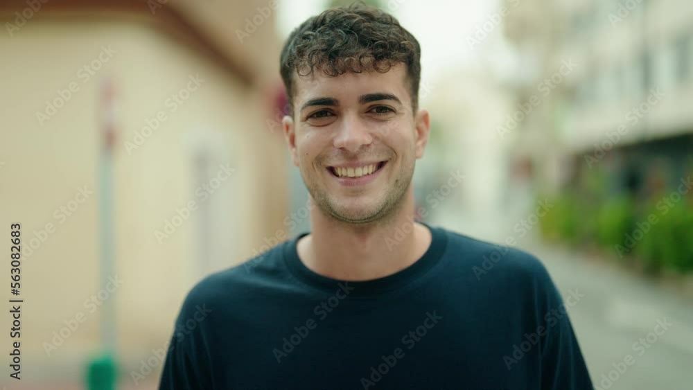 Young hispanic man smiling confident standing at street Young hispanic man smiling confident standing at street