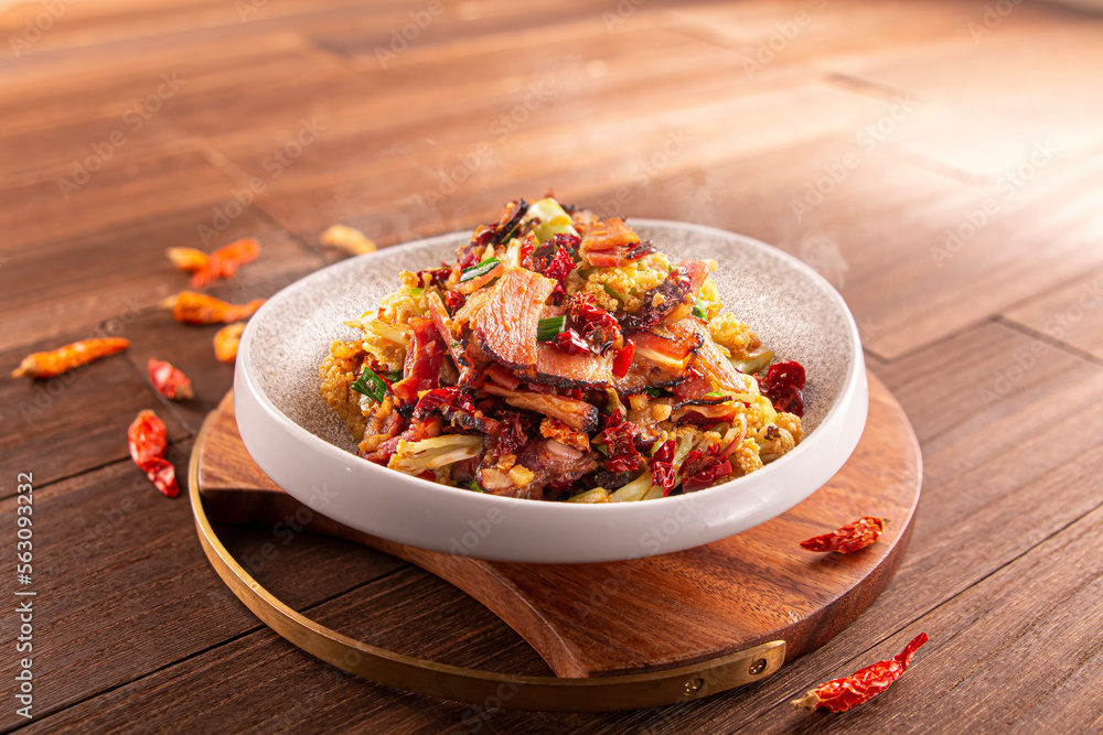 Spicy chili cauliflower fried pork and bacon served dish isolated on wooden table top view of Hong Kong food Spicy chili cauliflower fried pork and bacon served dish isolated on wooden table top view of Hong Kong food
