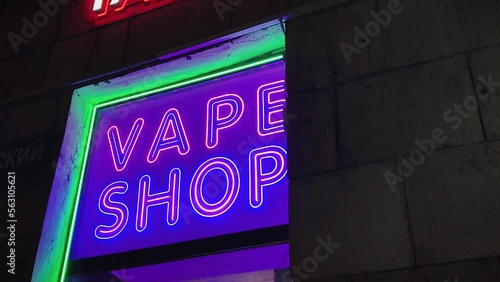 vape shop electronic cigarette neon colored window showcase sign lights glow up attracting customers on the street at night.concept vape shop.
