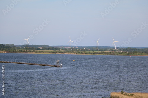 View to wind turbines from Unterwarnow river around Warnemünde Rostock, Germany photo