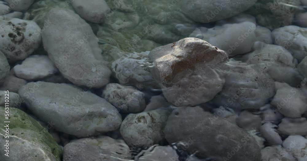 pebbles underwater on the seashore. waves wash the rocks. pebbles underwater on the seashore. waves wash the rocks.