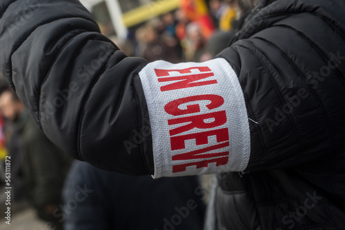 Closeup of man protesting in the street with cut and text in french : en greve, traduction in english : striking photo