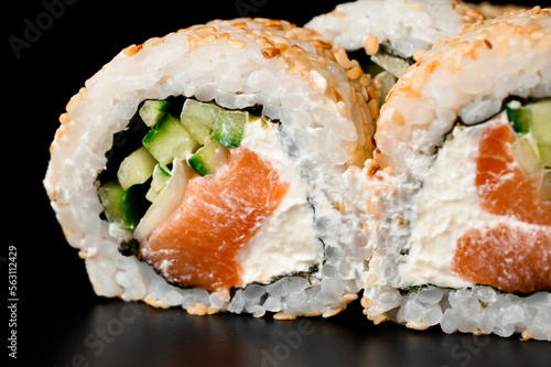 selective focus on the filling of sushi rolls california with smoked salmon, cream cheese, cucumber