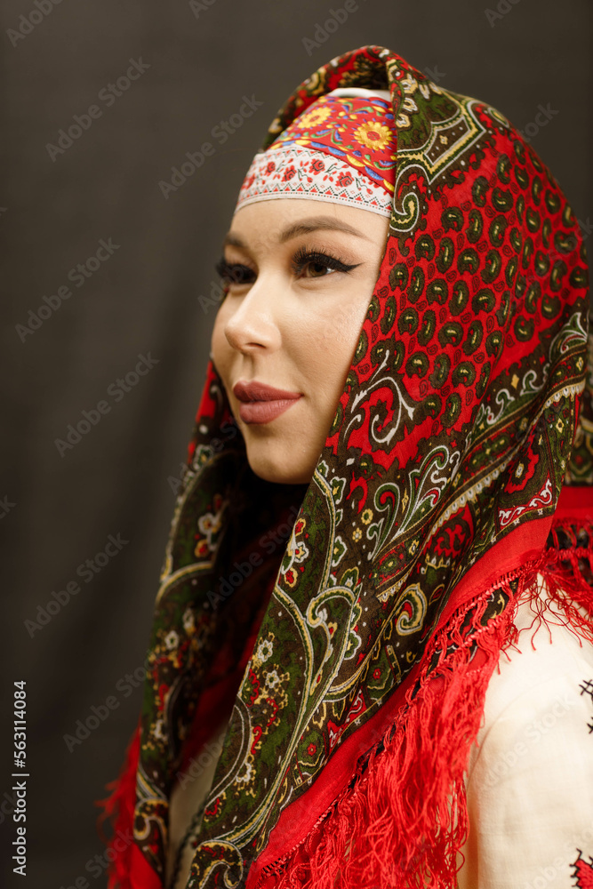 a girl in a Chuvash dress and with a red scarf on a dark background