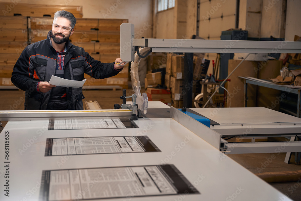 Adult man working in the woodhouse manufactory Adult man working in the woodhouse manufactory
