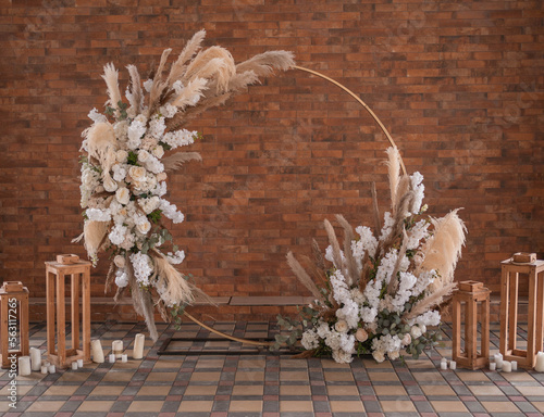 Minimalist round wedding arch, boho style wedding arch with leaves and pampas ros, decorated wedding arch in the mountain under the trees. Wedding day.