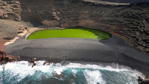 Europe, Spain, Lanzarote, Canary Islands - Charco de Los Clicos (Charco Verde) drone aerial view of green lagoon in Tymanfaya national park, Volcanic landscape - tourist attraction in biosfere reserve photo