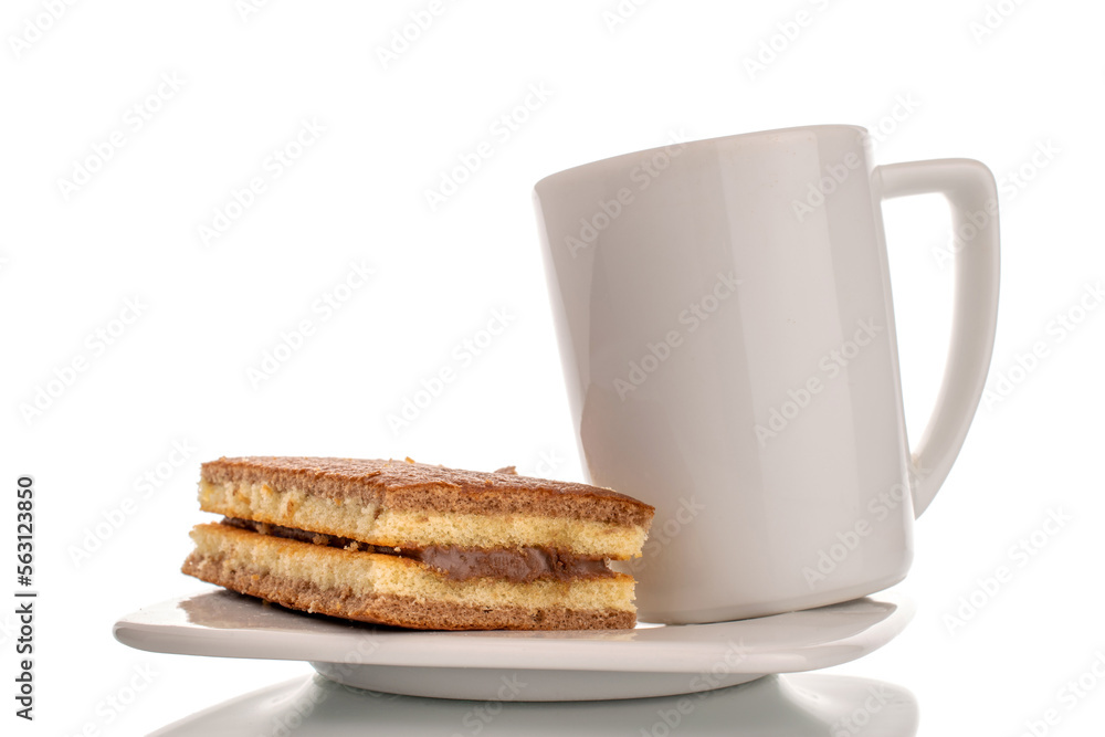 One mini cocoa biscuit on white ceramic saucer with white cup, macro isolated on white background. One mini cocoa biscuit on white ceramic saucer with white cup, macro isolated on white background.